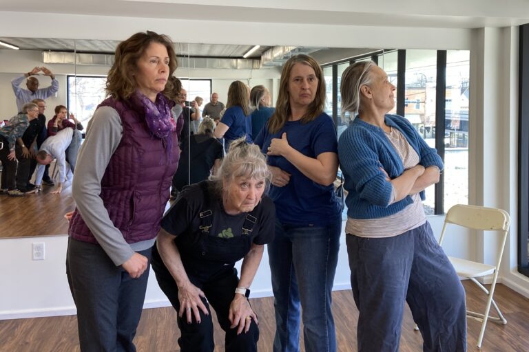 Four women pose in a drama class scene